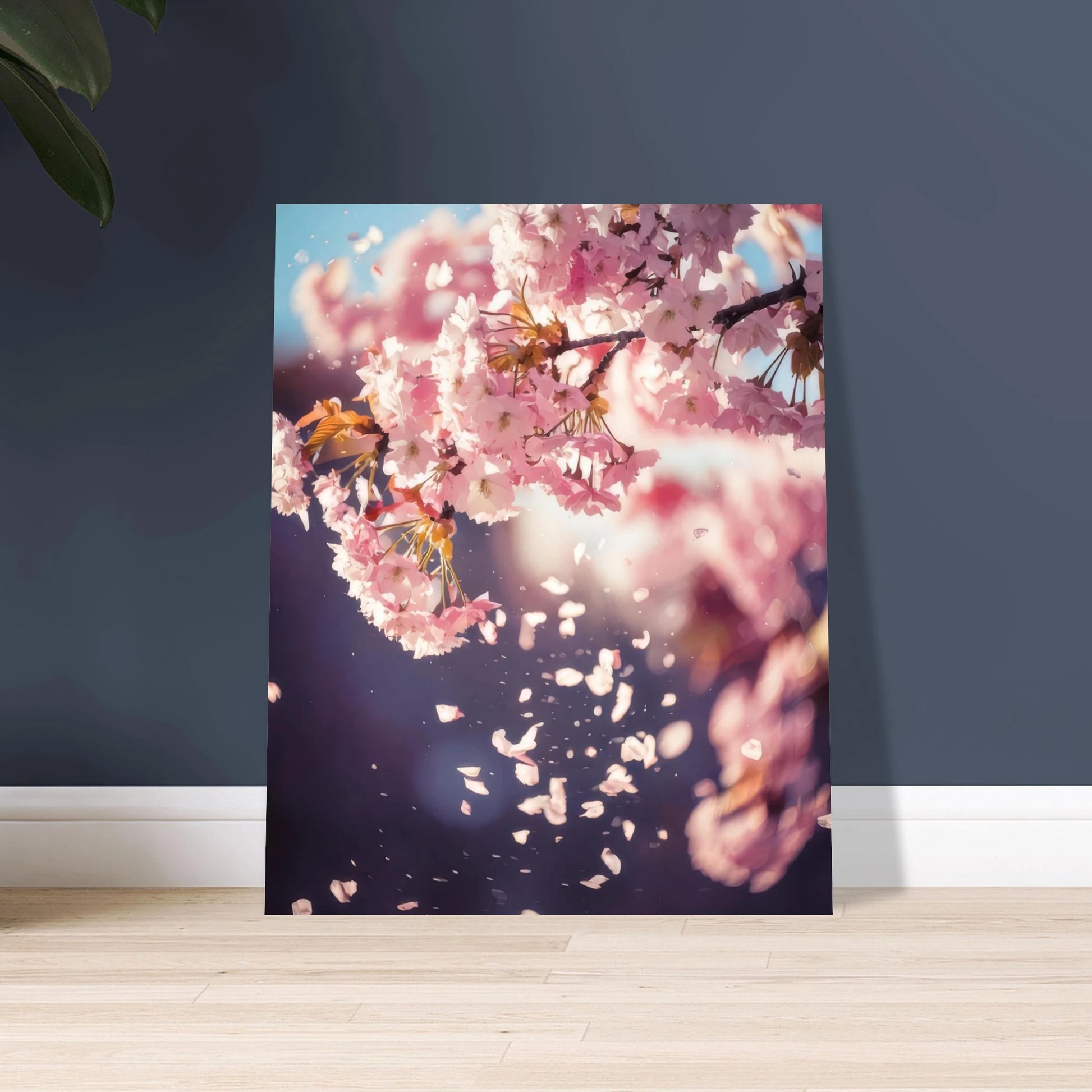 Dreamy pink and white cherry blossom branches with delicate petals falling against a soft, pale blue spring sky.