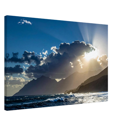 Sunrise over mountains with clouds and ocean waves
