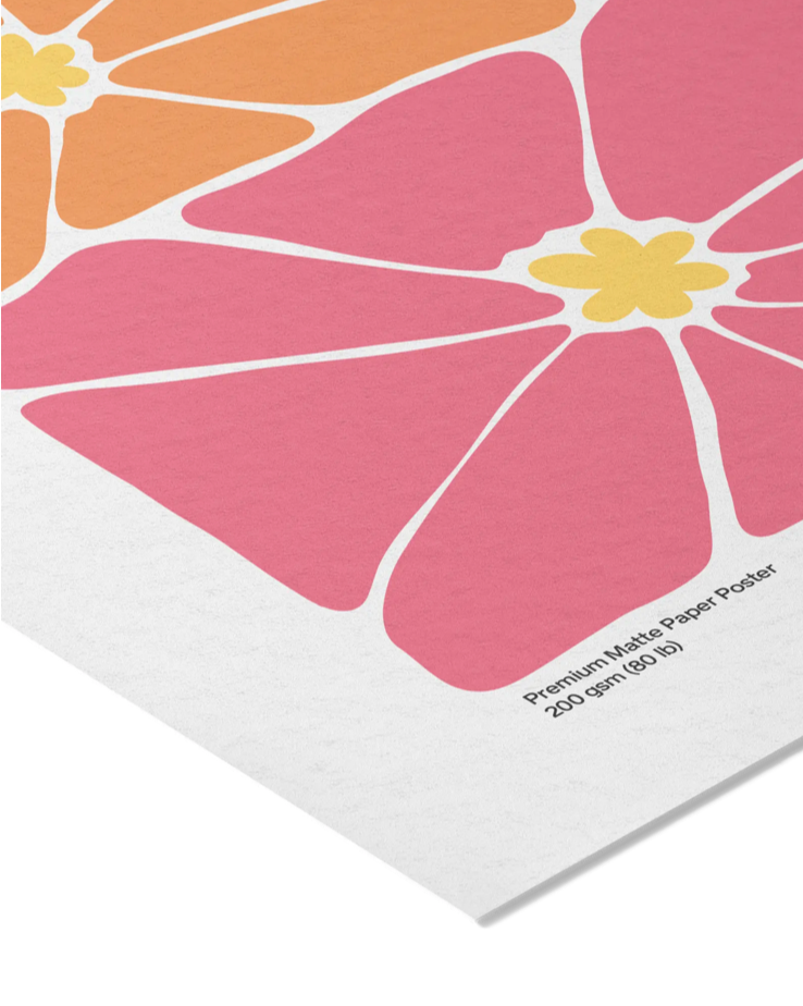 A close-up of a modern floral art print featuring large pink petals, orange and yellow sections, and a white paper border with printed text reading 'Premium Matte Paper Poster 200 gsm (90/lb)'.