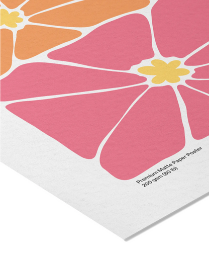 A close-up of a modern floral art print featuring large pink petals, orange and yellow sections, and a white paper border with printed text reading 'Premium Matte Paper Poster 200 gsm (90/lb)'.